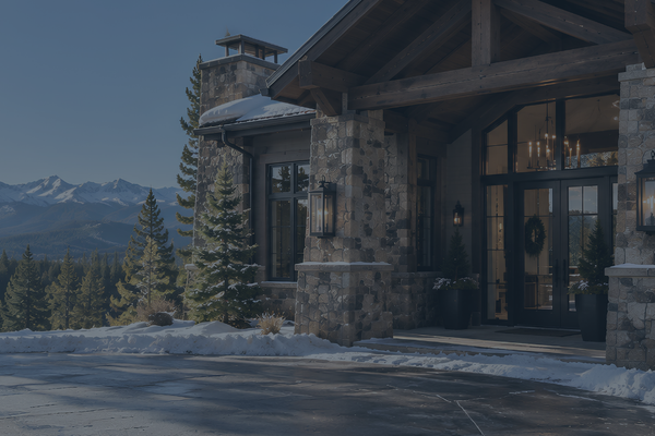 Pristine timber-frame entryway on a Pagosa Springs luxury mountain home featuring custom stone columns, south-facing paved driveway, and clear mountain views.